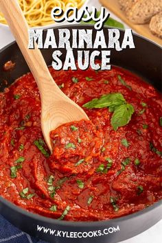 easy marinara sauce in a skillet with a wooden spoon and pasta on the side