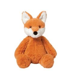 a small stuffed fox sitting on top of a white surface