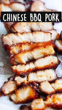 slices of meat sitting on top of a cutting board covered in bbq barbecue sauce