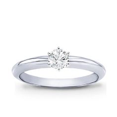 a white gold engagement ring with a single diamond