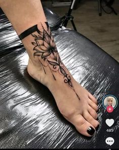 a woman's foot with a flower tattoo on it