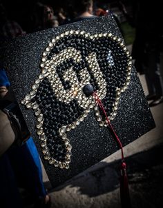 a decorated graduation cap with beads on it