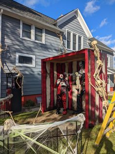 halloween decorations in the shape of skeletons and skeletons are on display at a house's front yard