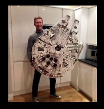 a man is holding a large model of the millennium falcon from star wars in his kitchen