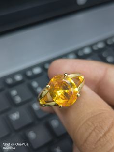 Yellow sapphire, also known as "Pukhraj" in Hindi, is a gemstone that belongs to the corundum family, just like blue sapphire. It is the yellow variety of corundum and is valued for its vibrant yellow color. Yellow sapphire is composed of aluminum oxide (Al2O3) with traces of iron that give it its yellow hue. The color of yellow sapphire can range from pale yellow to intense golden yellow. The most prized and valuable yellow sapphires typically exhibit a pure, vibrant yellow color without any hi Yellow Sapphire Oval Ring In Fine Jewelry Style, Fine Yellow Oval Sapphire Ring, Oval Yellow Sapphire Diamond Ring, Oval Yellow Sapphire Ring With Prong Setting, Yellow Sapphire Ring With Round Cut Gemstone, Yellow Oval Sapphire Ring With Prong Setting, Fine Citrine Jewelry For Promise, Fine Jewelry Yellow Sapphire Round Ring, Oval Yellow Sapphire Jewelry With Center Stone