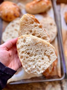 a person holding some bread in their hand