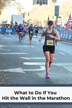 a woman running in a marathon with the words what to do if you hit the wall in the marathon