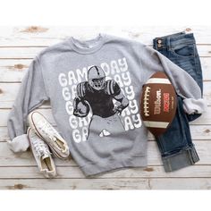 This makes the perfect vintage school spirit sweatshirt! Game Day! This distressed football sweatshirt is great for the sports moms and gift for high school football fans! This vintage football player is perfect on the popular Gildan brand sweatshirt. This vintage style sweatshirt will keep you warm throughout the football season!  A pre-shrunk, classic fit sweater that's made with air-jet spun yarn for a soft feel and reduced pilling. ** P R O D U C T **  - 50% cotton, 50% polyester  - Pre-shrunk  - Classic fit  - Direct to Garment print (no stencils or vinyl which means it will last a lot longer)   - Printed and Shipped in the USA  - Due to different monitor screens colors may vary ** S I Z I N G **  - Consult size chart in listings for measurements  - Sizing is Unisex for all tees, runs College Football Season Graphic Print Sweatshirt, Game Day Team Name Sweatshirt In Athletic Heather, Football Season Fan Gear Sweatshirt With Graphic Print, Game Day Fan Apparel Sweatshirt In Athletic Heather, Football Season Graphic Print Fan Gear Sweatshirt, Team-colored Graphic Print Sweatshirt For Football Season, Athletic Heather Sweatshirt For Game Day, College Football Season Letter Print Sweatshirt, College Sweatshirt With Letter Print For Football Season