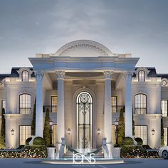 a large white building with columns and arches on the front entrance to it at night