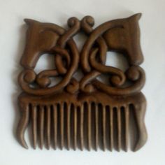 a wooden comb with an intricate design on it