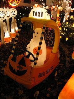 an orange car decorated with halloween decorations and lights