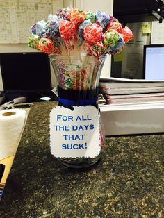 a vase filled with lots of candy sitting on top of a counter