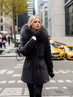 Fashionable and fierce, this coat is designed for those who want to stay warm without compromising on style. The soft faux fur-lined hood not only offers extra protection from the cold but also elevates the overall look of the coat. The cinched waistline provides a tailored, feminine fit, while the sleek front closure keeps the coat modern and functional. Ideal for both casual and formal settings, this coat can be styled with leather pants, jeans, or a chic dress, making it a versatile addition Cold Weather Outerwear With Detachable Hood, Hooded Faux Fur Parka With Fur Trim, Fall Hooded Faux Fur Jacket With Fur Trim, Fall Faux Fur Coat With Detachable Hood, Fall Faux Fur Hooded Jacket With Faux Fur Trim, Parka With Detachable Hood For Cold Weather, Fall Hooded Puffer Jacket With Faux Fur Trim, Hooded Puffer Jacket With Faux Fur Trim For Fall, Hooded Faux Fur Parka For Fall