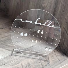 a clear glass plate with the word stella written in cursive writing on it