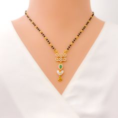 Crafted in 22k yellow gold, this iconic Mangal Sutra weighs 10.5 grams and features a beautiful heart-shaped CZ pendant, complemented by traditional black beads. The 16" necklace includes a 1.5" drop and 1" adjustable links, making it versatile for different necklines. Finished with a secure hook lock, this piece elegantly blends timeless tradition with modern sparkle, creating a heartwarming statement of love and style for any occasion. PRODUCT DETAILS Gold Purity(karat): 22k Item Weight(grams) Black 22k Gold Jewelry As A Gift, Black 22k Gold Jewelry Gift, Festive Black Necklace In 22k Gold, Black 22k Gold Jewelry For Wedding, Black 22k Gold Wedding Jewelry, Traditional Yellow Gold Jewelry With Black Beads, Black 22k Gold Necklace For Weddings, Elegant Black Temple Necklace As Gift, Elegant Black Temple Necklace Gift