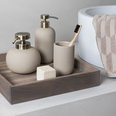 the bathroom accessories are arranged on the counter