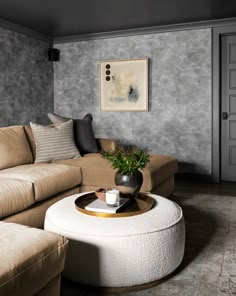 a living room filled with furniture and a white table in front of a painting on the wall