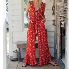 Kivari Quinn Floral Ruffle Bell Bottom Jumpsuit Size Xs New With Tags Embrace 70’s Nostalgia Our Floral Kivari Quinn Jumpsuit Is The Next Show Stopper. Floral Pattern Throughout, Elastic Waist , Hook And Eye Enclosure In Front, Pocketed, Frilly Wide Leg Bell Bottoms And Tie Front. This Is Sure To Be A Cult Classic! 100% Viscose Hand Wash Only This Is My Favorite Jumpsuit So I Purchased This One For A Back Up! The Compliments Are Endless. I Usually Pair Mine With A Cute Lace Bralette 58” From Sho Fitted Ruffled Jumpsuits And Rompers For Vacation, Fitted Ruffle Jumpsuits And Rompers For Vacation, Casual Red Ruffled Jumpsuits And Rompers, Casual Red Jumpsuits And Rompers With Ruffles, Red Fitted Jumpsuits And Rompers For Vacation, Red Fitted Jumpsuit For Vacation, Fitted Red Jumpsuits And Rompers For Vacation, Bell Bottom Jumpsuits, Free People Jumpsuit