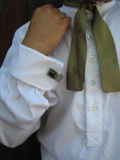 A classic wing-collar pullover shirt with French cuffs and ruching at the front and back yoke and cuffs. Cut from cotton jacquard. This shirt is straight out of the Old West, when formal wear was a bit more interesting. Wear it with a tailcoat, a frock coat, suit or vest. Vintage hematite cuff links not included (although we found these for a customer for only $20 extra). Contact us for pictures of current fabrics. This style would look great in a plaid, stripe, or numerous colors including blac Formal Shirt With Cuffed Sleeves And Fold Down Collar, Formal Shirt With Cuffed Sleeves For Fall, Formal Fall Shirt With Cuffed Sleeves, Fall Formal Shirt With Cuffed Sleeves, Elegant Dress Shirt With Fold Down Collar For Daywear, Classic Formal Dress Shirt With Cuffed Sleeves, Elegant Formal Dress Shirt With Cuffed Sleeves, Fall Elegant Dress Shirt With Fold Down Collar, Elegant Cotton Shirt With Cuffed Sleeves