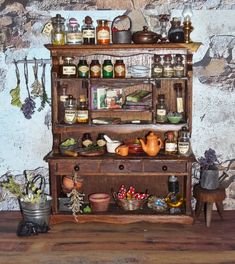 an old wooden shelf with spices and other items on it