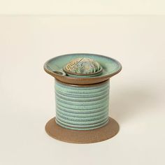 a spool of thread sitting on top of a white surface