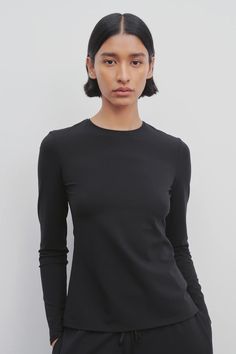 Iverness Top Black in Jersey – The Row Black Second-skin Tops For Workwear, Sleek High Stretch Tops With Thumbholes, Second-skin Crew Neck Tops With Thumbholes, Fitted Long Sleeve Top With Thumbholes Crew Neck, Fine Knit Long Sleeve Tops, Sleek Fine Knit Tops For Work, Sleek Fine Knit Tops For Workwear, Fitted Fine Knit Long Sleeve Crew Neck Top, Sleek Crew Neck Top With Minimal Stretch