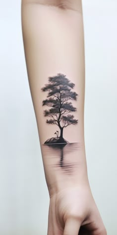 Detailed underarm tattoo illustration of a tree beside a calm lake, reflecting its silhouette in the water. Nature-inspired tattoo design emphasizing growth, serenity, and environmental connection. Tree And River Tattoo, Water And Tree Tattoo, Lake Reflection Tattoo, Tree Reflection Tattoo, Serene Tattoo, Nature Quarter Sleeve Tattoo, Tree And Birds Tattoo, Self Reflection Tattoo Ideas, Reverse Tattoo