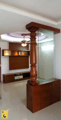 a living room with a ceiling fan and wooden furniture on the floor in front of it