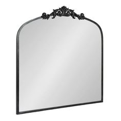 a large mirror with an ornate frame on the top and bottom part, in black