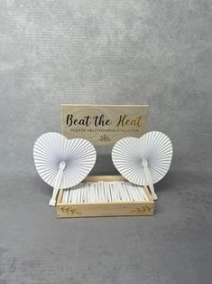 Handmade Rustic Wooden Crate and Sign Set with option to add Heart Shape Paper Fans. Beat the heat with our Heart Shape Paper Fans elegantly presented in a Handmade Rustic Wooden Crate. Unique wedding decor that's ideal for summer or beach weddings.  If purchasing the crate and sign, the items will be sent dis-assembled in order to ship out safely. To assemble the crate and sign you simply need to push the sign dowels into the pre drilled holes in the crate, and that is all. If ordering just the