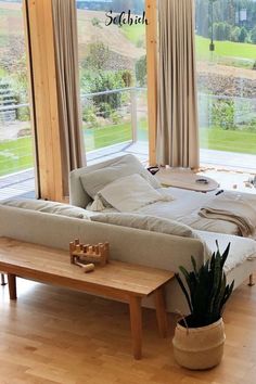 a living room filled with furniture and a wooden table next to a sliding glass door