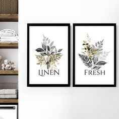 two framed art prints on the wall above a washer and dryer