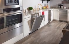 a kitchen with stainless steel appliances and white cabinets