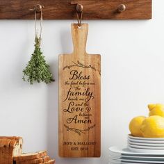 a wooden cutting board with the words, blessing and family on it hanging from a wall