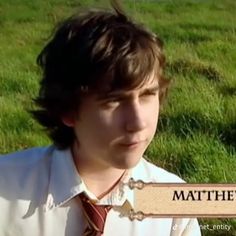 a young man wearing a shirt and tie in front of a sign that says, mathies