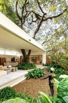 the modern house is surrounded by greenery and trees, as well as an outdoor living area