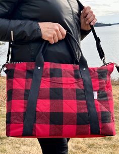 "The Oxbow Overnight Tote is ready to go on all your adventures! This new design by @Noodlehead451 is a sleek and stylish tote designed to reduce packing stress! It features a fun, quilted buffalo plaid exterior with a front pocket. The back of the bag has a double-layered waxed canvas trolley sleeve to fit over your rolling suitcase so you can breeze through airports. The inside of the bag is a sturdy canvas/hemp fabric with a double slip pocket. The base is a reinforced waxed canvas fabric. Carry the bag by its comfy rolled cotton webbing handles or wear it cross body with its adjustable 50\" strap. There is a leather cord zipper pull so you can get in and out of your bag with ease. Great bag for weekend getaways, winter cruises, or knitting retreats. Could also work as a diaper bag for Quilted Rectangular Travel Bag For Everyday Use, Everyday Quilted Rectangular Travel Bag, Red Quilted Travel Bag, Noodlehead Patterns, Winter Cruise, Hemp Fabric, Waxed Canvas, Buffalo Plaid, Leather Cord