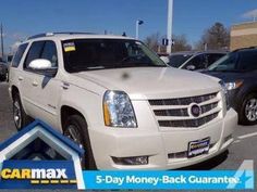 a white suv parked in a parking lot next to other cars with the words car max written on it