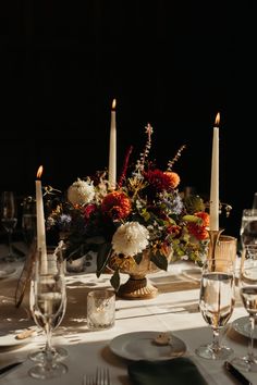 the table is set with candles and flowers