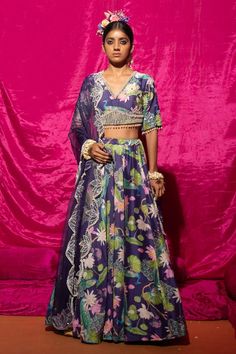 Purple lehenga with lotus, peacock print all over. Paired with sequin, pearl embroidered blouse and border embroidered dupatta.
Components: 3
Pattern: Printed, Embroidery
Type Of Work: Lotus, peacock, sequin, pearl
Neckline: V neck
Sleeve Type: Half sleeves
Fabric: Chanderi Silk, Organza Silk, Lining: Shantoon
Color: Purple
Other Details: 
Pearl embellished scallop border
Back cut-out blouse
Border embroidered sheer dupatta
Length:
Blouse: 15 inches
Lehenga: 44 inches
Occasion: Destination Weddi Bohemian Designer Lehenga With Printed Motifs, Festive Chanderi Lehenga With Printed Motifs, Festive Lehenga With Printed Motifs In Traditional Drape, Bohemian Choli With Printed Motifs For Eid, Bohemian Choli With Printed Motifs For Diwali, Silk Lehenga With Printed Motifs And Traditional Drape, Silk Lehenga With Printed Motifs In Traditional Drape, Festive Unstitched Lehenga With Printed Motifs, Festive Designer Lehenga With Printed Motifs