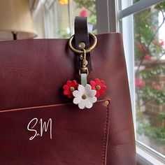 Handmade Triple Mini Flower Leather Bag Charm This charm is displayed on my medium Cognac tote to illustrate size and dimension. This listing is for the charm only - the tote is not included. This charm is handmade by deconstructing and upcycling some of my new and unused Portland Leather collection! Colors used: PLG's Beluga, Ruby, and Cucumber Lobster clasp is small enough to fit on a zipper to be used as a zipper pull, or big enough to hook onto an o-ring for your larger bags and crossbodies. Small Handmade Bag For Daily Use, Handmade Everyday Flower Bag, White Bag With Keychain For Everyday Use, Zipper Charms, Large Bag, O Ring, Color Choices, Cognac, Cucumber