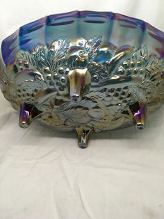 a decorative glass bowl on a white surface