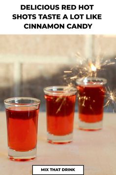 three shot glasses filled with red hot shots and sparklers in the background text reads delicious red hot shots taste a lot like cinnamon candy mix that drink