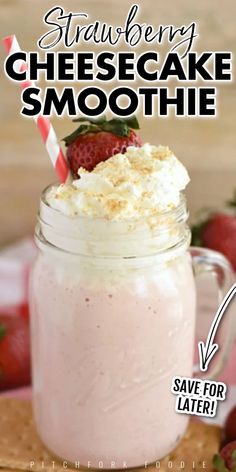 a strawberry cheesecake smoothie in a mason jar with strawberries on the side