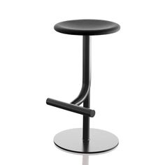 a black stool sitting on top of a white floor next to a metal pole and round base