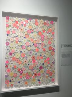 a white frame with flowers on it in front of a wall mounted art piece that reads clean bubbles