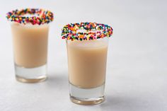 two glasses filled with liquid and sprinkles