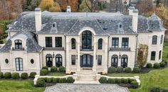 an aerial view of a large white mansion