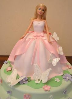 a barbie doll cake with butterflies on it