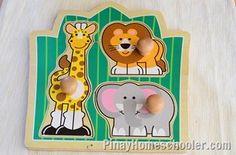 a wooden puzzle with animals and giraffes on it